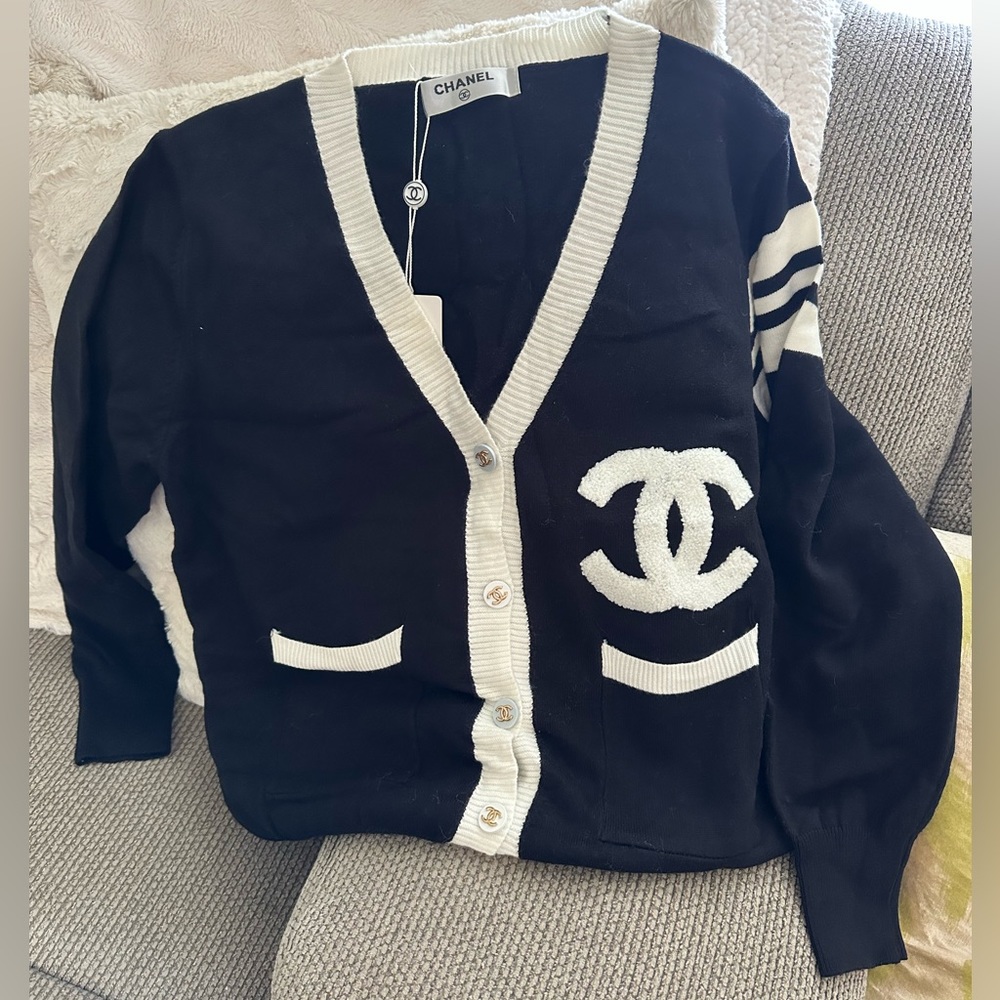 Medium button down sweater. Black and white never used. Light weight.
